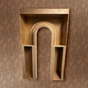 Set of gold decorative shelves against a patterned wall.