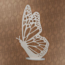 White butterfly cutout on a brown patterned background