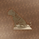 Decorative metal tiger sculpture on a patterned wall