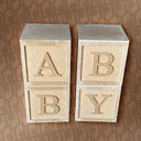 Three beige blocks with letters 'A', 'B', and 'Y' on a patterned background
