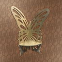Metallic butterfly wall art on a patterned brown background