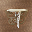 Butterfly-shaped wall shelf against a patterned wall