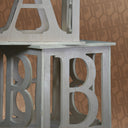 Decorative metal letters 'A', 'B', and 'C' on a patterned background