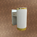 Decorative wall-mounted cabinet with white and gold design on a patterned brown background