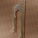 Decorative metal object with intricate design on a patterned wall