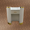 Decorative cabinet with gold accents on a patterned wall