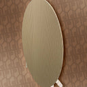Beige textured oval object against a patterned brown background