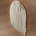 Wooden snowshoe against a patterned brown background