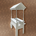 White decorative wall-mounted cart with a roof on a patterned brown background