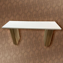 White shelf with green legs on a patterned wall